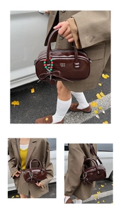 Detail of glossy dark brown patent leather pillow bag with charms and shoulder strap