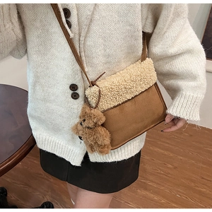 Detail of autumn plush messenger bag with brown leather and beige faux fur texture