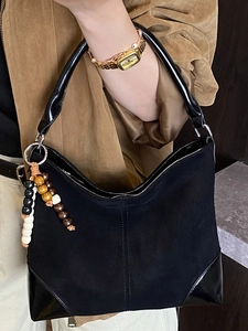 Retro black faux suede shoulder bag with wood bead charm and glossy leather trim