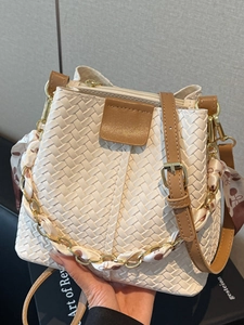 Fashionable woven bucket bag in cream white with brown leather trim and silk scarf detail