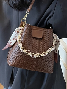 Chic dark brown woven bucket bag with cherry print scarf handle and golden chain strap
