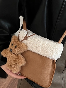 Brown suede crossbody bag with plush shearling trim and cute teddy bear charm