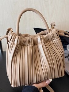 Minimalist beige ruched bucket bag with round handles and detachable strap for women