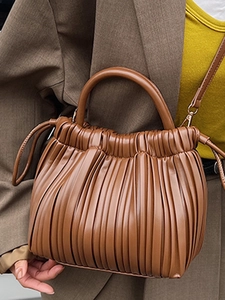 Chic warm brown accordion pleat bucket bag with round handle and adjustable strap