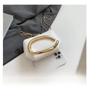 Macro view of white leather mini square bag showing golden metal buckle and size scale