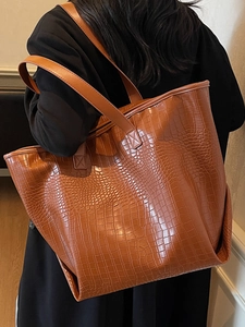 Large capacity caramel crocodile embossed tote bag for women showing back view shoulder wear