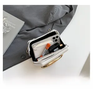 Internal view of the white mini leather crossbody bag showing storage for phone and lipstick