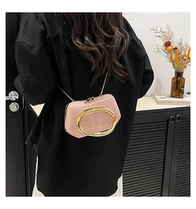 Close-up of pink mini bag with vintage metal ring buckle and gold chain strap