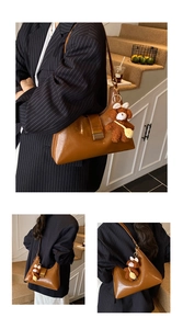 Brown faux leather crescent underarm bag shown on model with cute bear charm
