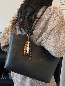 Minimalist black PU leather tote bag with vintage wood bead tassel and knotted strap