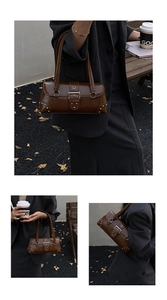 Close-up of dark brown vintage baguette bag with silver studs and buckle details