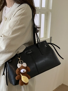 Minimalist black leather tote bag with cute plush puppy charm for women daily commuting