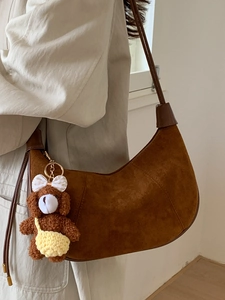 Brown suede leopard hobo bag with a cute plush bear charm in a crescent shape