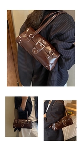 Detailed view of brown glossy leather bag with punk studs and large metal buckle