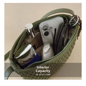 Detail of olive green quilted bag internal capacity showing daily essentials and leather