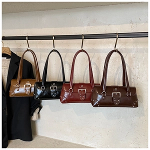 Detail view of four vintage faux leather underarm bags with studs and metal buckles