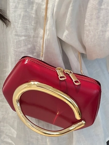 Chic red patent leather mini crossbody bag with circular gold metal handle and chain strap