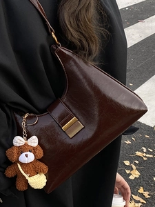 Chic dark brown glossy shoulder bag with vintage metal buckle and cute bear charm decor