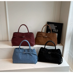 Detail view of large faux suede leopard print tote bags in four trendy fall colors