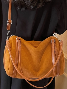 Brown faux suede Boston pillow bag with adjustable shoulder strap and silver hardware