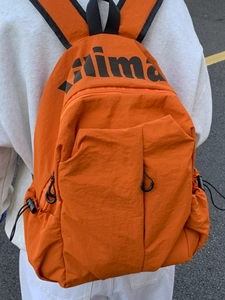 Vibrant orange lightweight nylon travel backpack with high capacity and side pockets