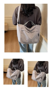 Detail view of the gray waterproof canvas tote bag with cartoon pattern and shoulder strap