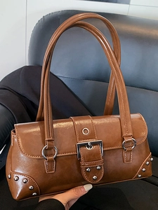 Brown vintage style shoulder bag with silver rivet details and metallic buckle