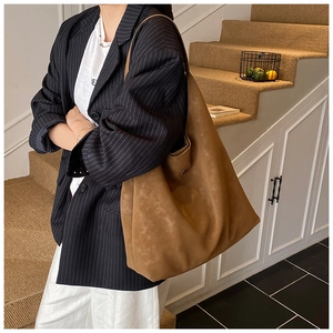 Détail d'un sac cabas kaki mat montrant la texture et la longue bandoulière réglable