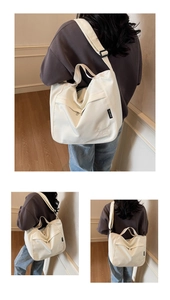 Detail view of off-white waterproof tote bag featuring embroidery and adjustable strap