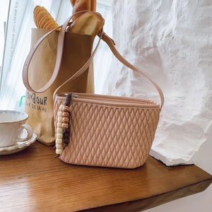 Chic quilted crossbody bucket bag with beaded tassel and pink minimalist design