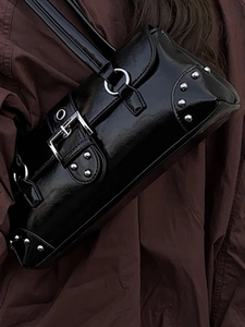 Chic black patent leather underarm bag with silver rivets and grunge aesthetic hardware