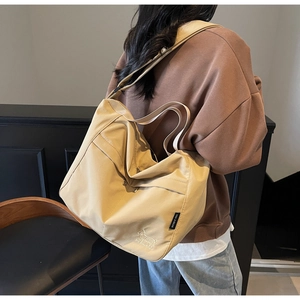 Detail view of khaki canvas tote with animal embroidery and wide shoulder strap