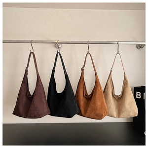 Detail showing four matte suede tote bags in dark brown black caramel and off-white