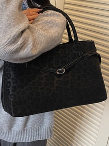 Chic black leopard print suede tote bag with dual handles and elegant silver buckle detail