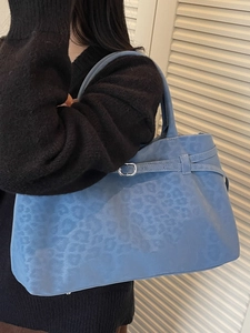 Large blue leopard print suede tote bag with decorative side straps and silver hardware