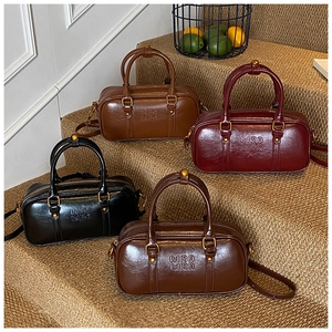 Detail view of retro Boston bags in four colors with Mira Mira embossing and vintage hardware