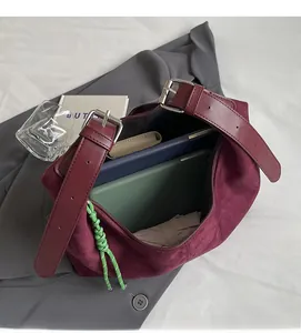 Interior view showing the large capacity of the burgundy suede tote bag with tablet and daily items