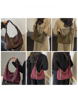 Detail view of large hobo bags in vintage brown and burgundy with green woven rope charms