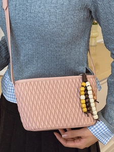 Pink quilted shoulder bag with woven chain and wooden bead charm, 2025 autumn fashion style