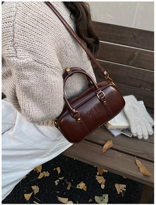 Detail of vintage dark brown leather Boston bag with Mira Mira embossed lettering