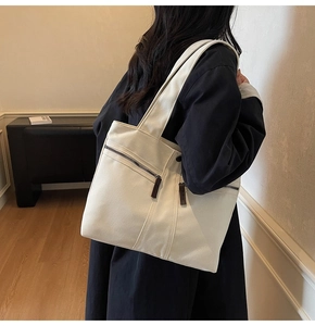 Detail of minimalist canvas tote bag with front zipper pocket for daily commute