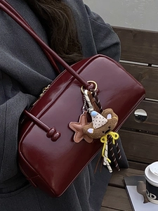 Retro deep red bowling bag for women with plush bear charm and glossy finish shoulder strap