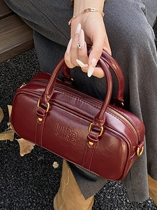 Retro burgundy leather cylindrical handbag with Mira Mira embossing for women