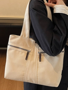 Minimalist beige canvas tote bag with large capacity and stylish zipper details