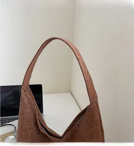 Close-up of the wide, durable shoulder strap and textured leopard print on this tote bag