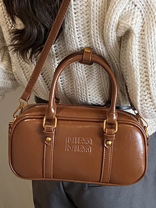Retro brown Boston handbag in oily leather finish with Mira Mira embossed logo and top handle