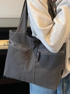 Minimalist dark grey canvas tote bag with large capacity and leather zipper details