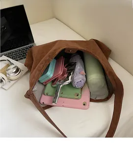 Spacious interior of leopard print tote bag holding tablet, umbrella, and water bottle