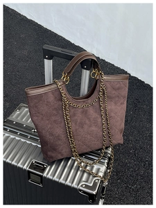 Macro detail of large diamond lattice tote bag on a metallic suitcase for travel use