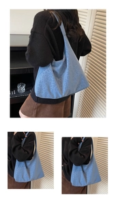 Detail of blue faux leather shoulder bag with textured leopard pattern and sleek strap